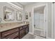 Bathroom vanity featuring granite countertops, framed mirrors, stylish lighting, and a shower with glass doors at 10921 Grand Haven Ave, Las Vegas, NV 89134
