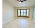 Open bedroom offers a bay window and tiled flooring at 10921 Grand Haven Ave, Las Vegas, NV 89134