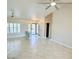 Bright open living area with tiled flooring, plantation shutters, ceiling fans, and secure front entrance at 10921 Grand Haven Ave, Las Vegas, NV 89134