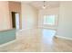 Bright living room featuring tile floors, plantation shutters and an open layout and access to other rooms at 10921 Grand Haven Ave, Las Vegas, NV 89134