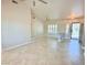 Bright living room showcasing tile flooring, plantation shutters, a ceiling fan, and a secure front entrance at 10921 Grand Haven Ave, Las Vegas, NV 89134