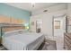 Comfortable main bedroom featuring a wood-accented bed frame and an ensuite bathroom entrance at 10921 Grand Haven Ave, Las Vegas, NV 89134