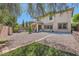 Large backyard featuring gravel, landscaping, and a view of the home's exterior at 11074 Caramel Crest Ct, Las Vegas, NV 89135