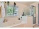 Modern bathroom with a soaking tub, separate shower, and decorative accents at 11074 Caramel Crest Ct, Las Vegas, NV 89135
