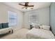 Neutral bedroom with a window, bench, and a comfortable bed at 11074 Caramel Crest Ct, Las Vegas, NV 89135