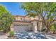 Charming two-story home features a tile roof, stucco siding, and mature landscaping in a suburban neighborhood at 11074 Caramel Crest Ct, Las Vegas, NV 89135