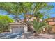Lovely two-story home with mature landscaping and a spacious driveway, showcasing its curb appeal at 11074 Caramel Crest Ct, Las Vegas, NV 89135