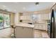 Spacious kitchen boasts white cabinets, a center island with bar stools, and stainless steel appliances at 11074 Caramel Crest Ct, Las Vegas, NV 89135