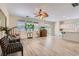 Open-concept living room with light wood floors and neutral tones, flowing into the kitchen area at 11074 Caramel Crest Ct, Las Vegas, NV 89135