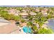 Captivating aerial view highlighting community homes with backyard pools, mature trees, and peaceful surroundings at 11649 Royal Derwent Dr, Las Vegas, NV 89138