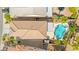 Aerial view of a tile roof home with a backyard pool, lush landscaping, and mature trees at 11649 Royal Derwent Dr, Las Vegas, NV 89138