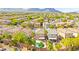 Expansive aerial view of a residential community featuring well-maintained homes and lush landscaping with mountain views at 11649 Royal Derwent Dr, Las Vegas, NV 89138