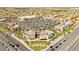 Aerial view of a shopping center featuring multiple stores, ample parking, and tree lined streets at 11649 Royal Derwent Dr, Las Vegas, NV 89138