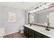 Bathroom showcasing double vanity with a large mirror and updated fixtures at 11649 Royal Derwent Dr, Las Vegas, NV 89138