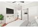 Virtually staged bedroom with hardwood floors, closet with built-in shelving and modern décor at 11649 Royal Derwent Dr, Las Vegas, NV 89138