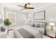 Staged bedroom with hardwood floors, large bed, and neutral decor at 11649 Royal Derwent Dr, Las Vegas, NV 89138