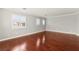 Bright bonus room featuring hardwood floors and plantation shutters on windows at 11649 Royal Derwent Dr, Las Vegas, NV 89138