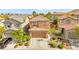 Well-manicured two-story home with tile roof and desert landscaping at 11649 Royal Derwent Dr, Las Vegas, NV 89138