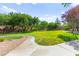 Expansive green space surrounded by mature trees, perfect for outdoor activities and relaxation at 11649 Royal Derwent Dr, Las Vegas, NV 89138