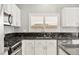 Modern kitchen features updated appliances and bright, shuttered windows at 11649 Royal Derwent Dr, Las Vegas, NV 89138