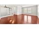 Spacious living area with hardwood floors, staircase, and lots of natural light at 11649 Royal Derwent Dr, Las Vegas, NV 89138