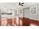 Bright living room with wood floors connecting the kitchen and outside at 11649 Royal Derwent Dr, Las Vegas, NV 89138