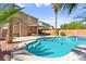 Inviting backyard pool and spa featuring lush landscaping, a covered patio, and a serene outdoor living space at 11649 Royal Derwent Dr, Las Vegas, NV 89138