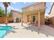 Inviting backyard pool with covered patio and lush, tropical landscaping at 11649 Royal Derwent Dr, Las Vegas, NV 89138