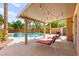 Outdoor patio area with overhead lighting overlooks the pool, spa, and patio furniture at 11649 Royal Derwent Dr, Las Vegas, NV 89138