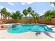 Inviting pool and spa surrounded by desert landscaping and lush palm trees at 11649 Royal Derwent Dr, Las Vegas, NV 89138