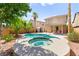Backyard pool and spa with tropical landscaping and covered patio area at 11649 Royal Derwent Dr, Las Vegas, NV 89138