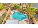 Aerial view of a backyard pool with a spa, surrounded by lush landscaping and palm trees at 11649 Royal Derwent Dr, Las Vegas, NV 89138