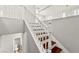 Staircase with hardwood steps, white railing and bannister, and access to the bathroom at 11649 Royal Derwent Dr, Las Vegas, NV 89138