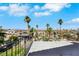 Elevated backyard view showing a patio and mature trees in a sunny setting at 1385 Morning Sun Way, Las Vegas, NV 89110