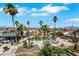 Expansive backyard with a luxurious pool, lush greenery, and mature palm trees at 1385 Morning Sun Way, Las Vegas, NV 89110