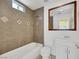 Cozy bathroom with a shower-tub combo, tiled walls, and a mirrored vanity for grooming at 1385 Morning Sun Way, Las Vegas, NV 89110