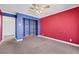 Bedroom with red and blue walls, ceiling fan and built in shelving at 1385 Morning Sun Way, Las Vegas, NV 89110