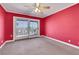 Bedroom with red walls, ceiling fan and sliding glass doors to backyard at 1385 Morning Sun Way, Las Vegas, NV 89110