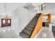 Welcoming foyer with staircase and stylish tile floors with a view of the bar area at 1385 Morning Sun Way, Las Vegas, NV 89110