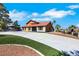 Attractive home featuring ample parking, a red tile roof, and complemented by lush artificial turf for a modern touch at 1385 Morning Sun Way, Las Vegas, NV 89110