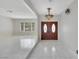 Elegant foyer featuring sleek tile flooring, a decorative chandelier, and double doors, creating a grand entrance at 1385 Morning Sun Way, Las Vegas, NV 89110