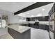 Modern kitchen features granite countertops, dark cabinetry, and stainless steel appliances at 1385 Morning Sun Way, Las Vegas, NV 89110