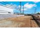 Expansive land featuring block wall fencing and mature palm trees; build your dream home here at 1385 Morning Sun Way, Las Vegas, NV 89110