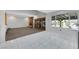 Open-concept living room featuring tile flooring, a brick fireplace, and backyard views at 1385 Morning Sun Way, Las Vegas, NV 89110