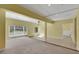 Spacious living room featuring large windows, tile and carpet flooring, and a ceiling fan at 1385 Morning Sun Way, Las Vegas, NV 89110