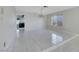 Open-concept living room features tiled flooring and a view into the kitchen at 1385 Morning Sun Way, Las Vegas, NV 89110