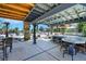 A covered outdoor kitchen and bar area offers backyard entertaining with clear sight lines to the pool at 1385 Morning Sun Way, Las Vegas, NV 89110
