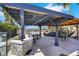 Entertainers backyard featuring an outdoor kitchen with bar seating under an expansive pergola at 1385 Morning Sun Way, Las Vegas, NV 89110