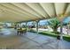 Covered patio with seating area and views of the landscaped backyard and pool at 1385 Morning Sun Way, Las Vegas, NV 89110
