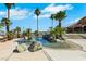 Beautiful pool featuring rock features and mature palm trees, offering a resort-style oasis at 1385 Morning Sun Way, Las Vegas, NV 89110